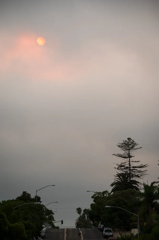 Afternoon sun obscured by clouds and smoke from the Valley Fire. San Diego, CA